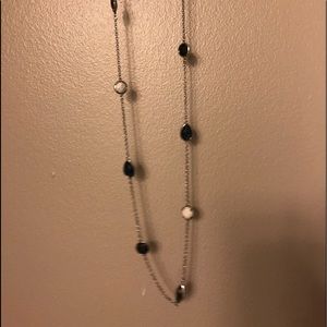 Long necklace with navy and cream accents.